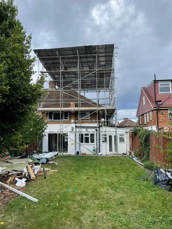 House wrapped in a scaffold tent during the roof rebuild
