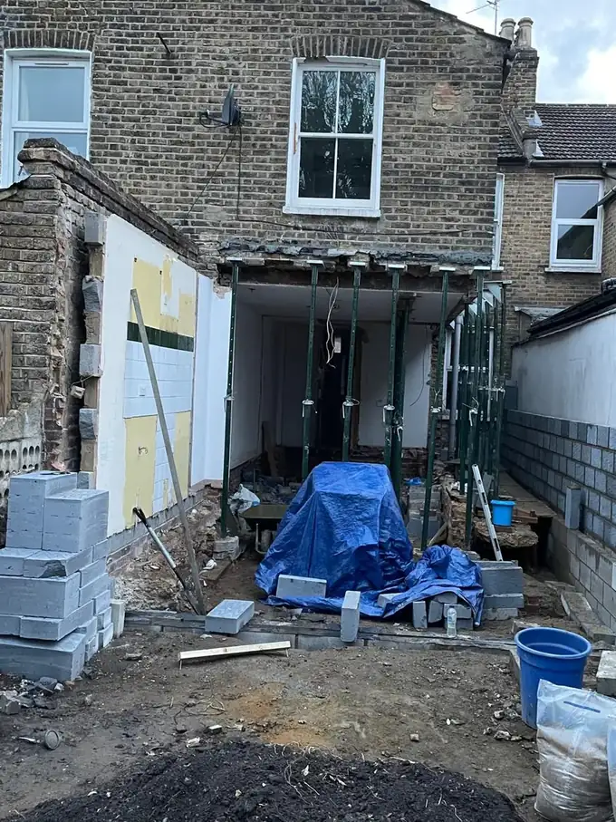 Rear of the house mid-build, blockwork walls up and props in