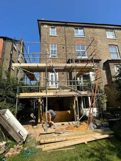 Scaffold up and the first-floor frame going in