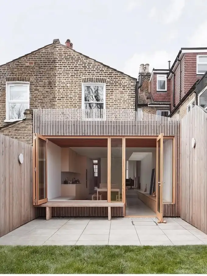 The finished cedar-clad extension opening onto the patio and lawn