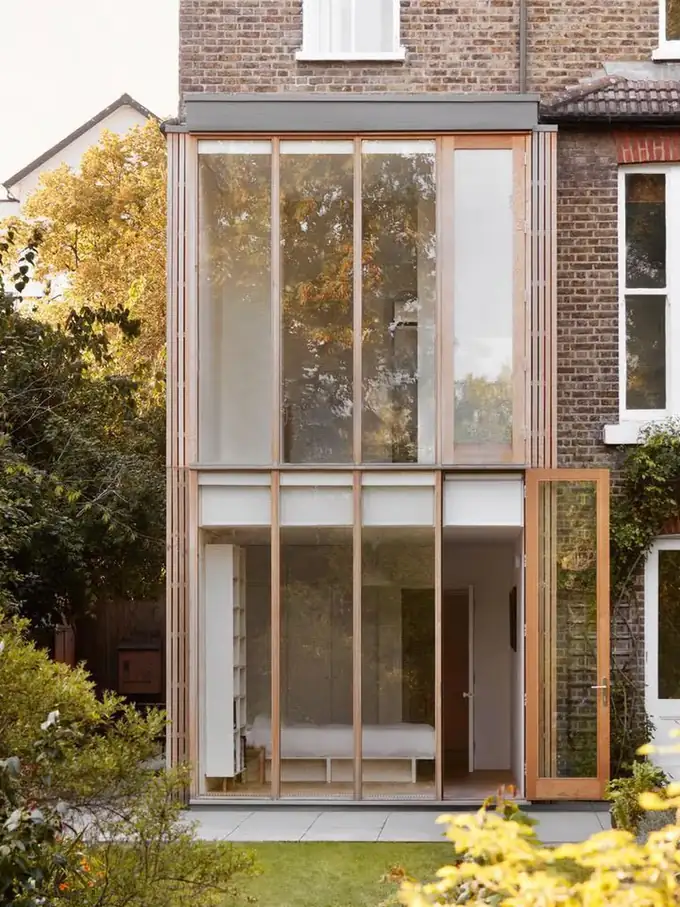 The finished two-storey extension with full-height oak-framed glazing